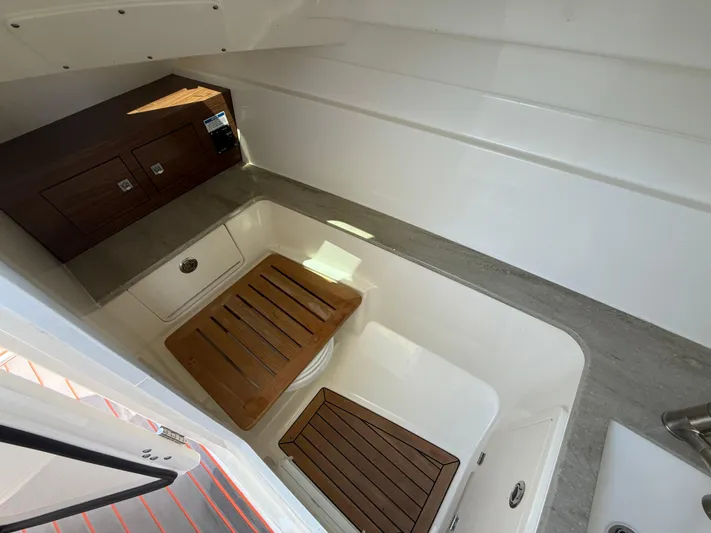  Yacht Photos Pics Interior of 2019 Boston Whaler 320 Vantage boat with wooden accents and storage compartments.