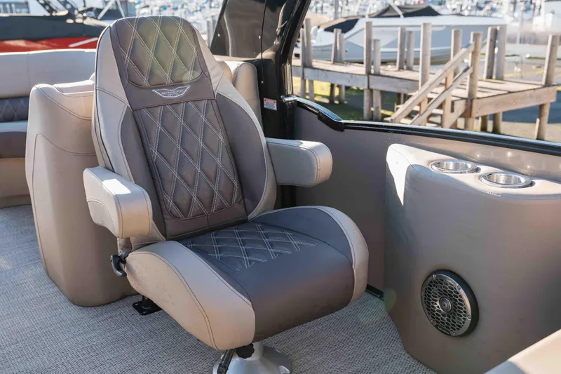  Yacht Photos Pics Luxurious seating on 2023 Bennington R25 FBAST boat, featuring diamond-stitched upholstery and cup holders.