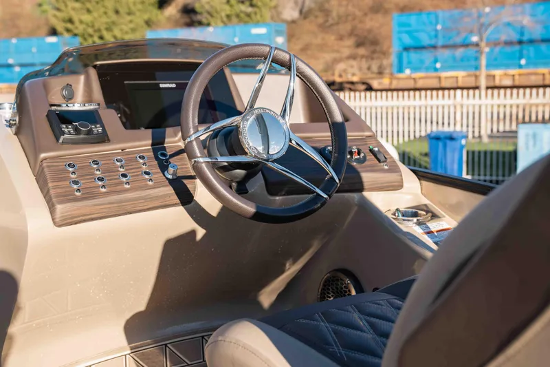  Yacht Photos Pics 2023 Bennington R25 FBAST boat dashboard with steering wheel and control panel.