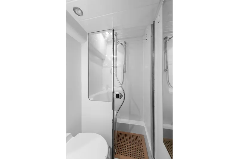  Yacht Photos Pics Shower area in 2003 Princess 23 m yacht, featuring modern fixtures and wooden floor mat.