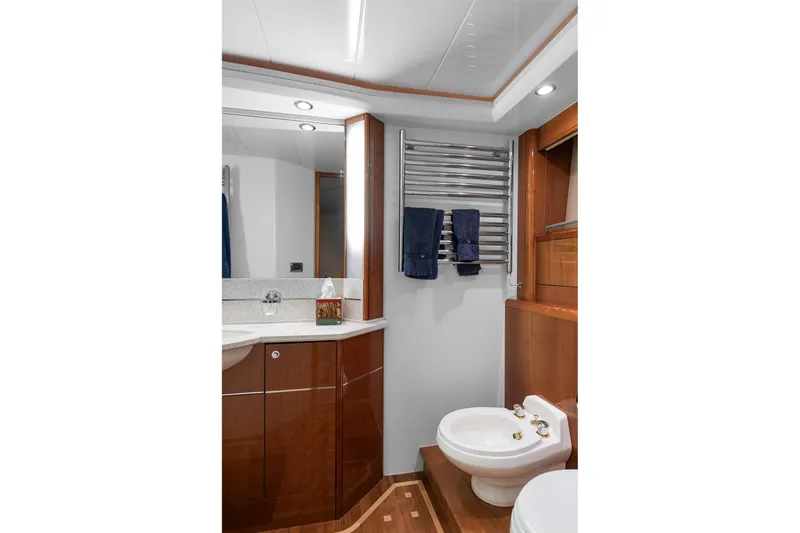  Yacht Photos Pics Luxurious bathroom in 2003 Princess 23m yacht with wood cabinetry and modern fixtures.