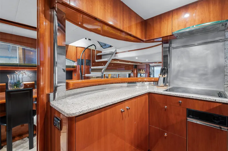  Yacht Photos Pics Luxurious kitchen interior of 2003 Princess 23m yacht with wood cabinetry and granite countertops.