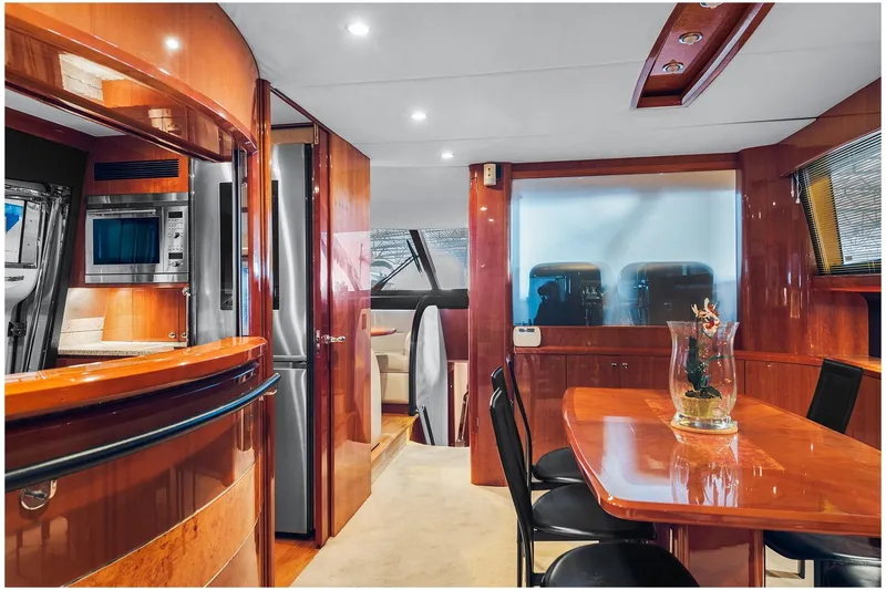  Yacht Photos Pics Luxurious interior of a 2003 Princess 23m yacht with elegant wood finishes and modern amenities.