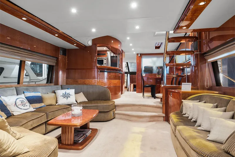  Yacht Photos Pics Luxurious interior of a 2003 Princess 23m yacht with elegant wood finishes and plush seating.
