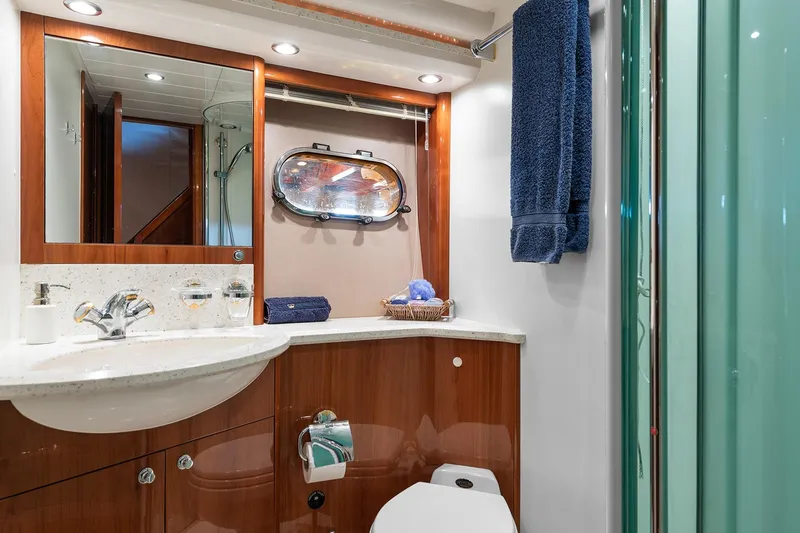  Yacht Photos Pics Luxurious bathroom in 2003 Princess 23m yacht with elegant wood finishes and modern fixtures.