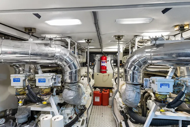  Yacht Photos Pics Engine room of a 2003 Princess 23m yacht with polished metal pipes and equipment.