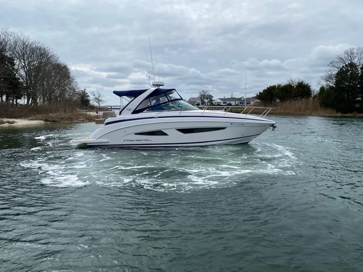  Yacht Photos Pics 2015 Regal 32 Express boat cruising on a calm, scenic waterway.