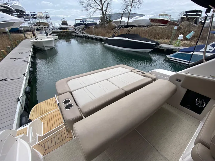  Yacht Photos Pics 2015 Regal 32 Express boat with spacious seating at a marina dock.