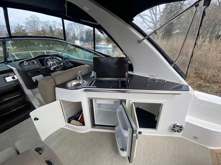  Yacht Photos Pics 2015 Regal 32 Express boat interior with kitchenette, sink, and seating area.