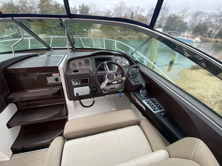  Yacht Photos Pics 2015 Regal 32 Express boat cockpit with steering wheel and control panel.