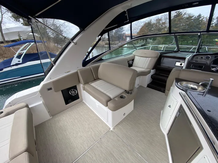  Yacht Photos Pics 2015 Regal 32 Express boat interior with beige seating and modern amenities.