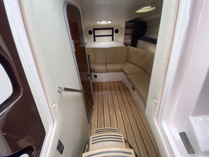  Yacht Photos Pics Interior of 2015 Regal 32 Express boat with seating and wood flooring.