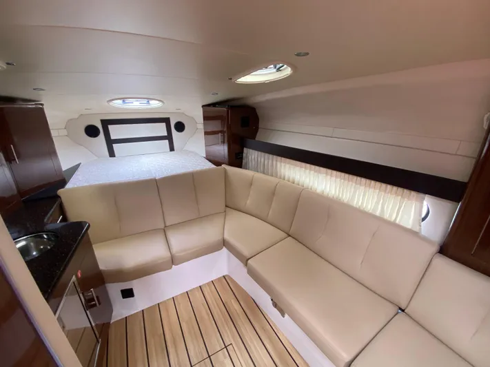  Yacht Photos Pics Interior of 2015 Regal 32 Express boat with beige seating and wood flooring.