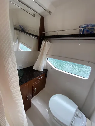  Yacht Photos Pics 2015 Regal 32 Express bathroom with modern fixtures and window view.