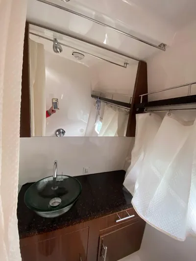  Yacht Photos Pics 2015 Regal 32 Express bathroom with glass sink and modern fixtures.