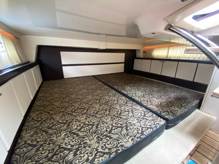  Yacht Photos Pics 2015 Regal 32 Express cabin interior with patterned bedding and modern design.