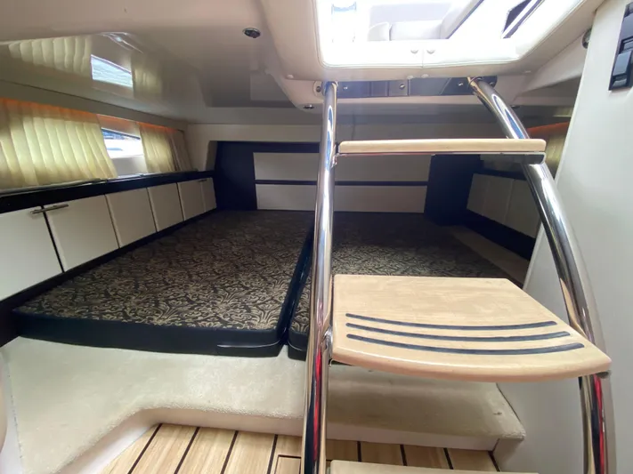  Yacht Photos Pics Interior cabin of 2015 Regal 32 Express boat with stairs and bed.