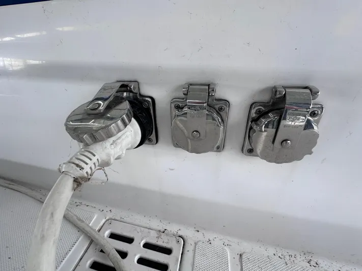  Yacht Photos Pics 2008 Donzi 38 ZSF boat electrical outlets with chrome covers and plugged-in cable.