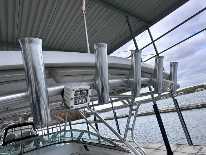  Yacht Photos Pics 2008 Donzi 38 ZSF boat with rod holders, docked under a metal canopy.