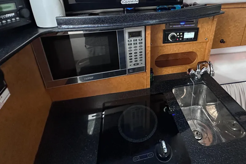  Yacht Photos Pics 2008 Donzi 38 ZSF boat kitchen with microwave, sink, and modern appliances.