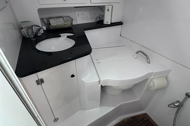  Yacht Photos Pics 2008 Donzi 38 ZSF boat bathroom with sink, toilet, and storage cabinets.
