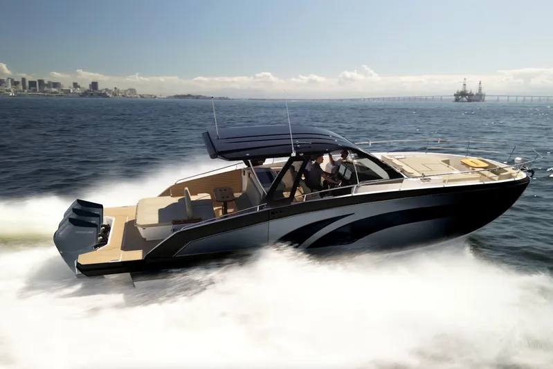  Yacht Photos Pics 2025 Hanover 447 boat cruising on open water with city skyline in background.