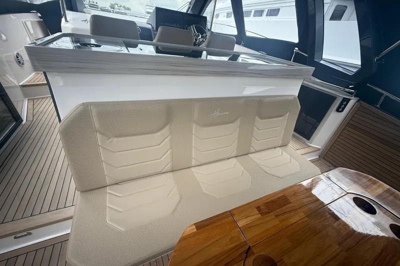  Yacht Photos Pics Luxurious interior of 2025 Hanover 447 yacht with elegant seating and wooden table.