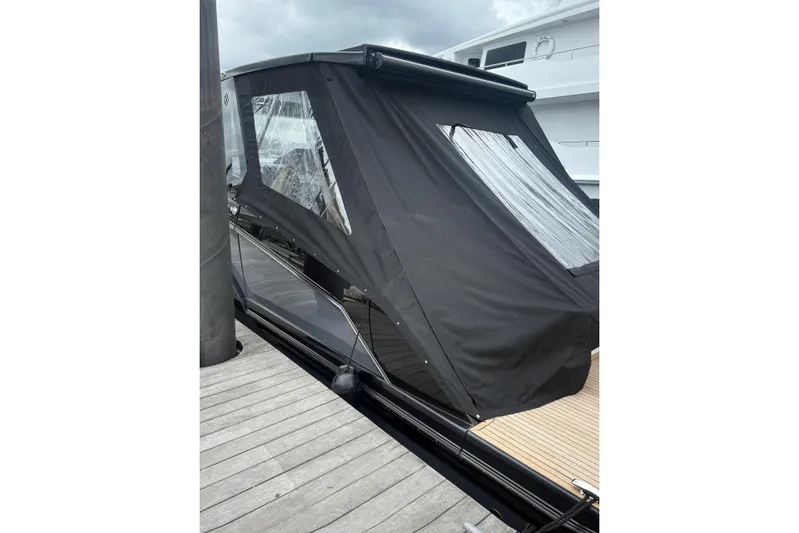  Yacht Photos Pics 2025 Hanover 447 yacht with black canopy docked at marina.