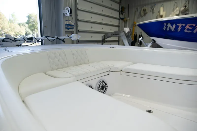  Yacht Photos Pics 2025 Contender 26 Bay boat interior with white seating in a garage setting.