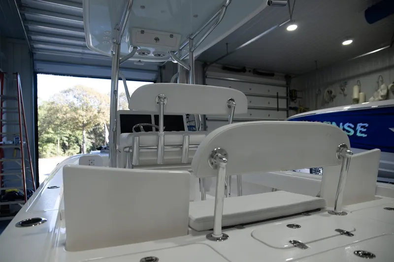 Yacht Photos Pics 2025 Contender 26 Bay boat interior in a garage, showcasing seating and storage features.