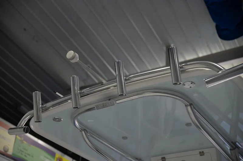  Yacht Photos Pics 2025 Contender 26 Bay boat with stainless steel rod holders under a metal roof.