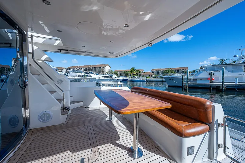 Emry Yacht Photos Pics Luxurious 2009 Aicon 64 yacht deck with seating, table, and marina view.