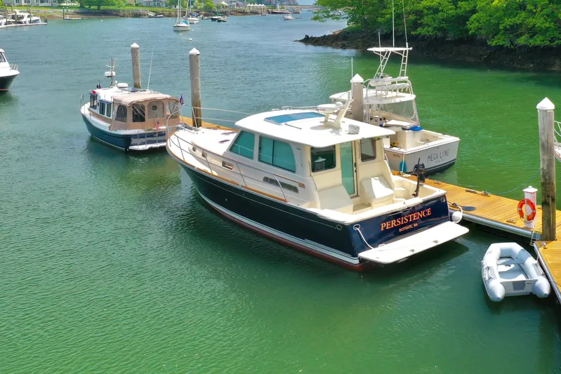 Persistence Yacht Photos Pics 2011 Sabre 40 Sedan yacht docked in a serene marina setting.