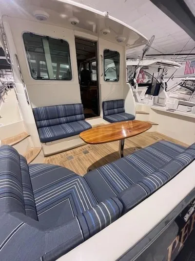 Persistence Yacht Photos Pics 2011 Sabre 40 Sedan yacht with striped seating and wooden table on deck.