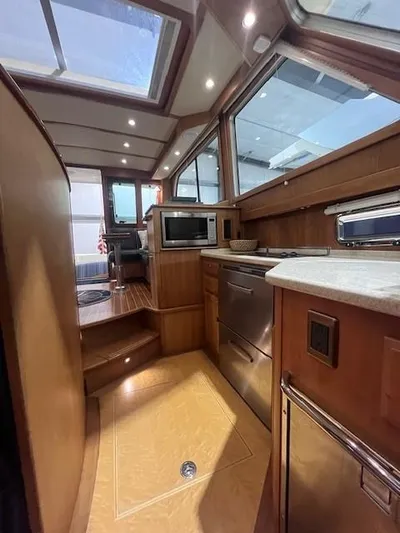 Persistence Yacht Photos Pics Interior of 2011 Sabre 40 Sedan yacht with modern kitchen and wood finishes.
