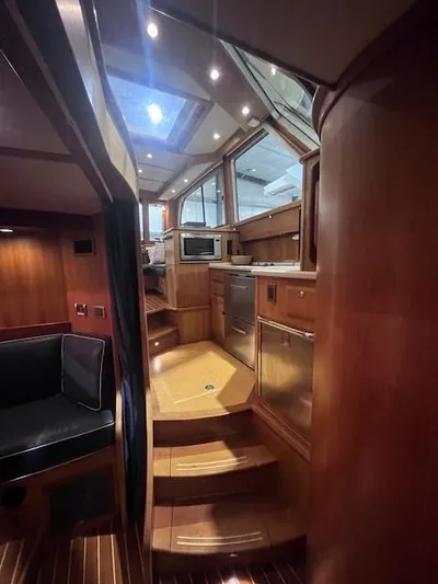 Persistence Yacht Photos Pics Interior of 2011 Sabre 40 Sedan yacht with wood finish and modern kitchen amenities.