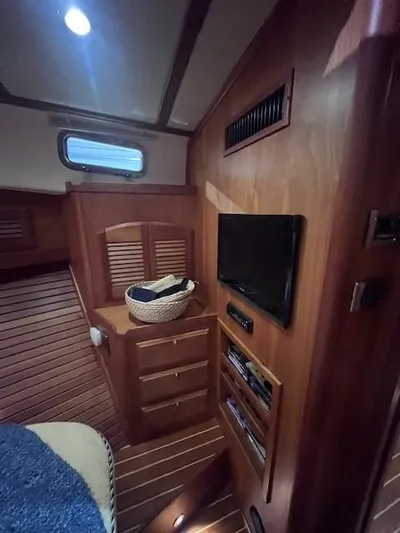 Persistence Yacht Photos Pics 2011 Sabre 40 Sedan interior with wood paneling, TV, and storage drawers.