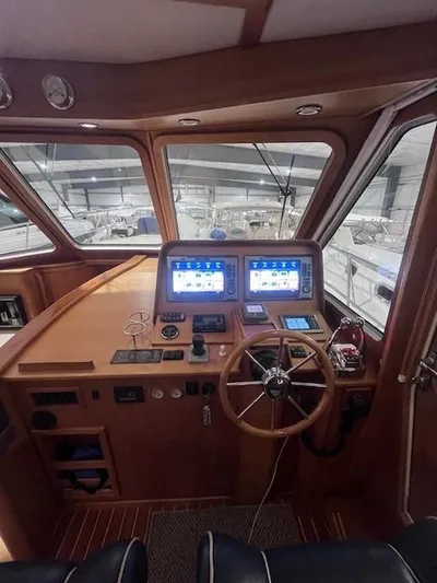 Persistence Yacht Photos Pics 2011 Sabre 40 Sedan helm with dual navigation screens and wooden steering wheel.