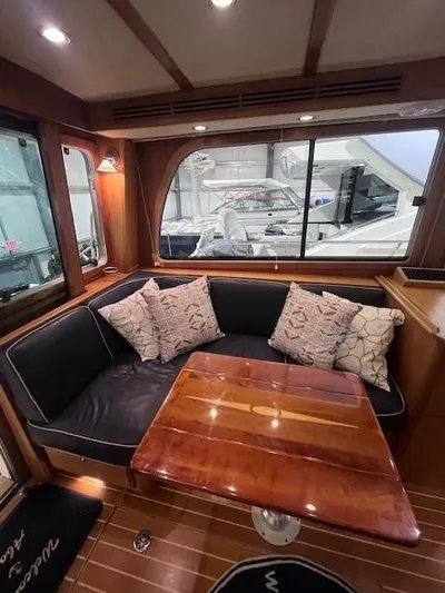 Persistence Yacht Photos Pics Luxurious interior of a 2011 Sabre 40 Sedan yacht with elegant seating and wooden table.