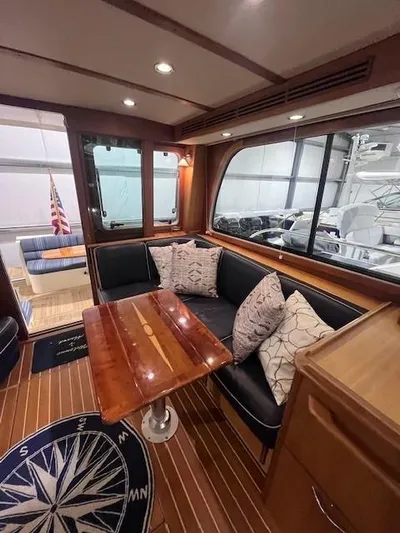 Persistence Yacht Photos Pics 2011 Sabre 40 Sedan interior with wooden table, cushioned seating, and nautical decor.