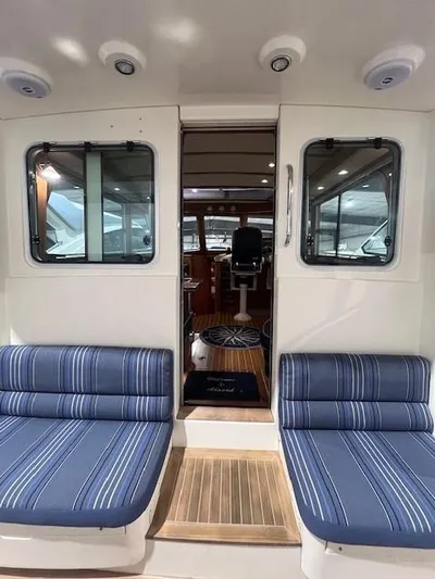 Persistence Yacht Photos Pics 2011 Sabre 40 Sedan interior with striped seating and wooden flooring.