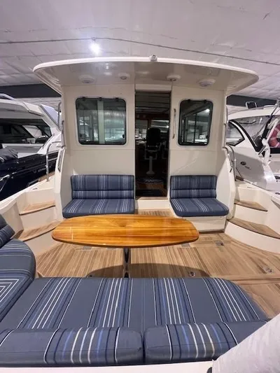 Persistence Yacht Photos Pics 2011 Sabre 40 Sedan yacht interior with striped seating and wooden table.
