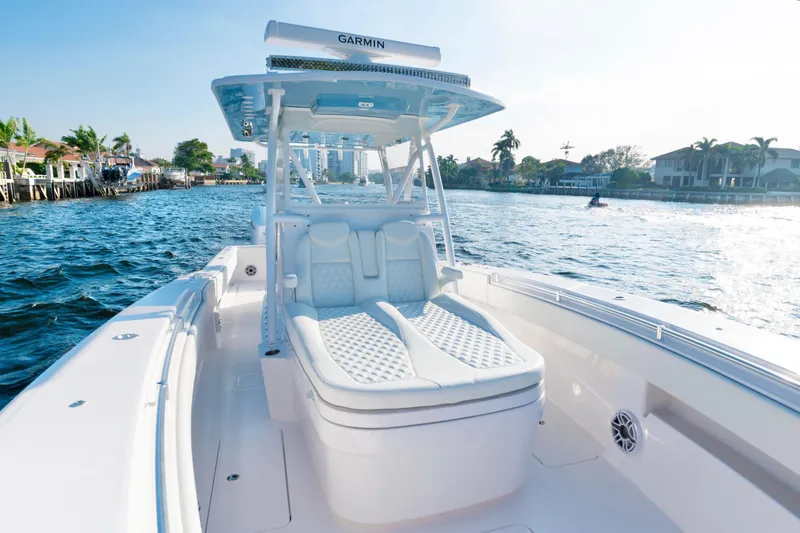 Freedom Frigate Yacht Photos Pics 2025 Invincible 36 Open Fisherman boat on water, featuring luxurious seating and Garmin equipment.