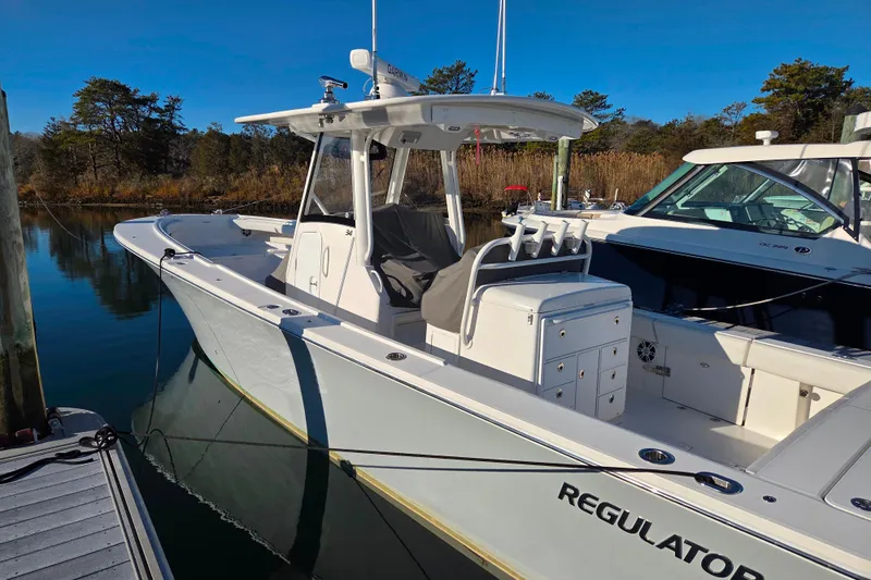 Three Ladies Yacht Photos Pics 2021 Regulator 34 boat docked in a serene marina setting.