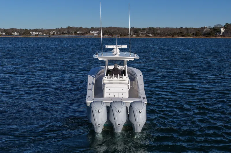 Three Ladies Yacht Photos Pics 2021 Regulator 34 boat with triple engines on calm water.