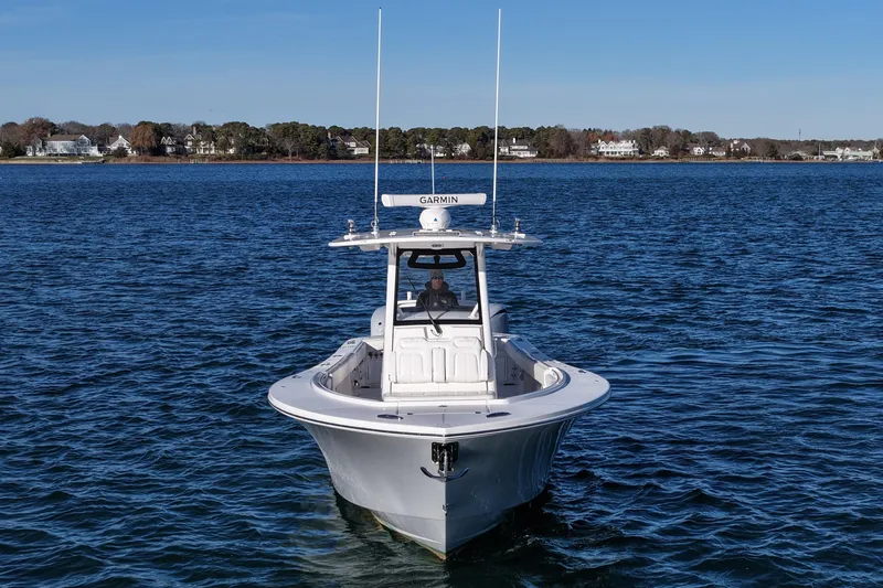 Three Ladies Yacht Photos Pics 2021 Regulator 34 boat on calm water with coastal background.