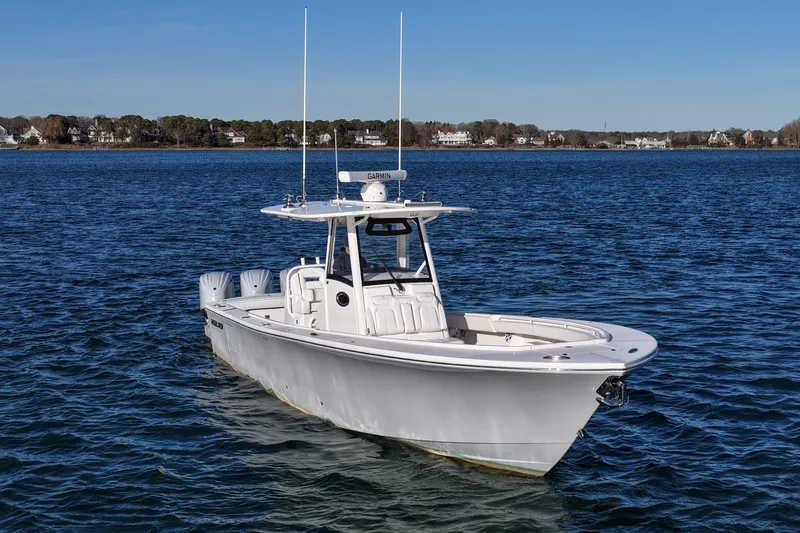 Three Ladies Yacht Photos Pics 2021 Regulator 34 boat on calm water with clear blue sky background.