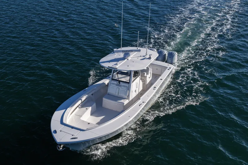 Three Ladies Yacht Photos Pics 2021 Regulator 34 boat cruising on open water, aerial view.