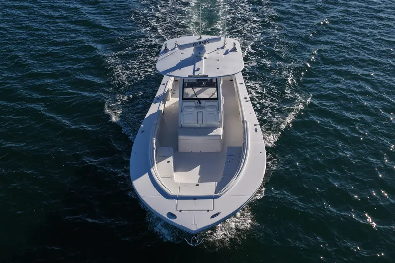 Three Ladies Yacht Photos Pics 2021 Regulator 34 boat cruising on open water, aerial view.