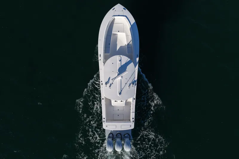 Three Ladies Yacht Photos Pics Aerial view of 2021 Regulator 34 boat cruising on dark water.